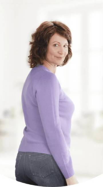 A woman in a purple shirt posing for a photograph