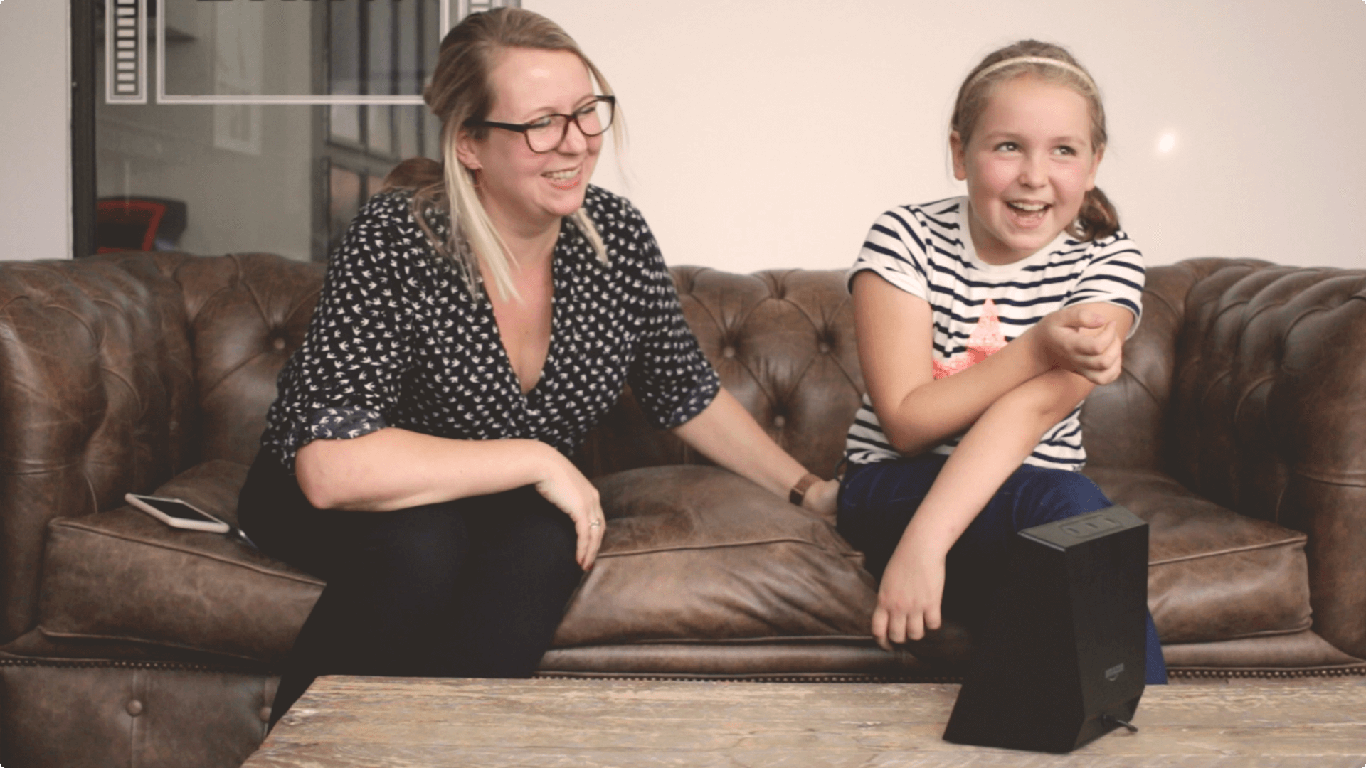 A daughter and mother laughing whilst playing parents versus kids