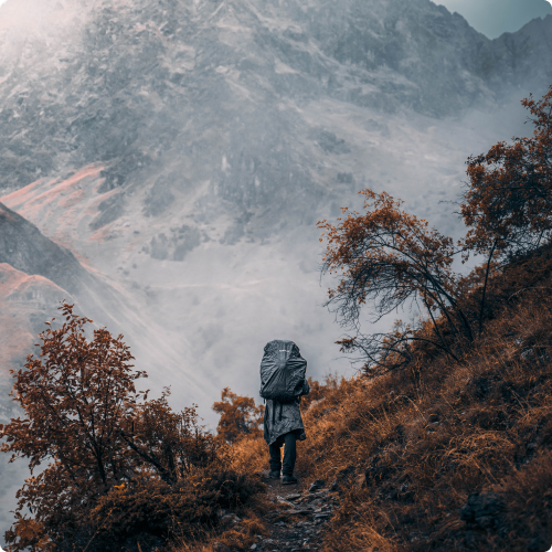 A person walking on a path in the mountains