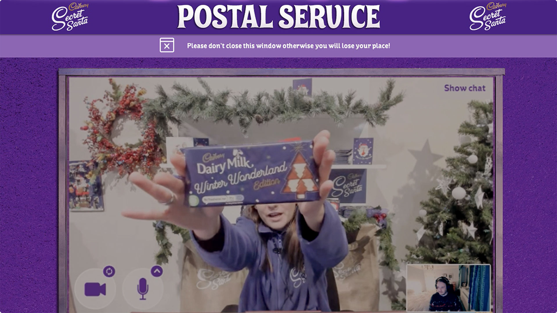 a person holding up a dairy milk bar 