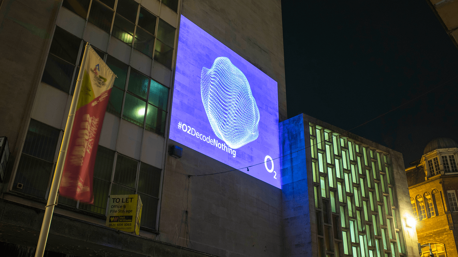 A light billboard with #O2DecodeNothing on it