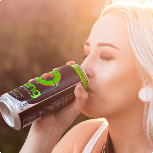 woman drinking from a can