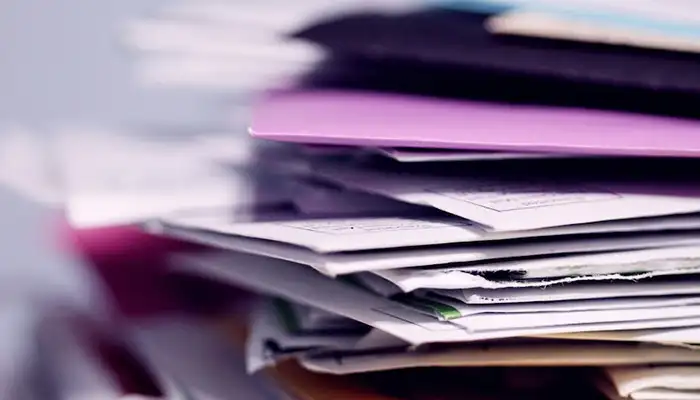 A pile of paperwork, receipts and folders