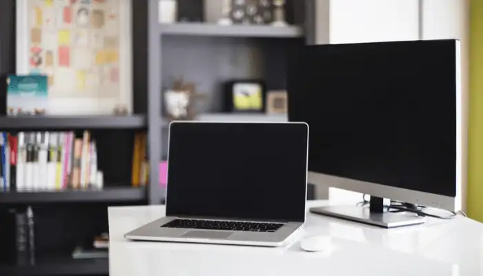 Image of two laptops in a home office space