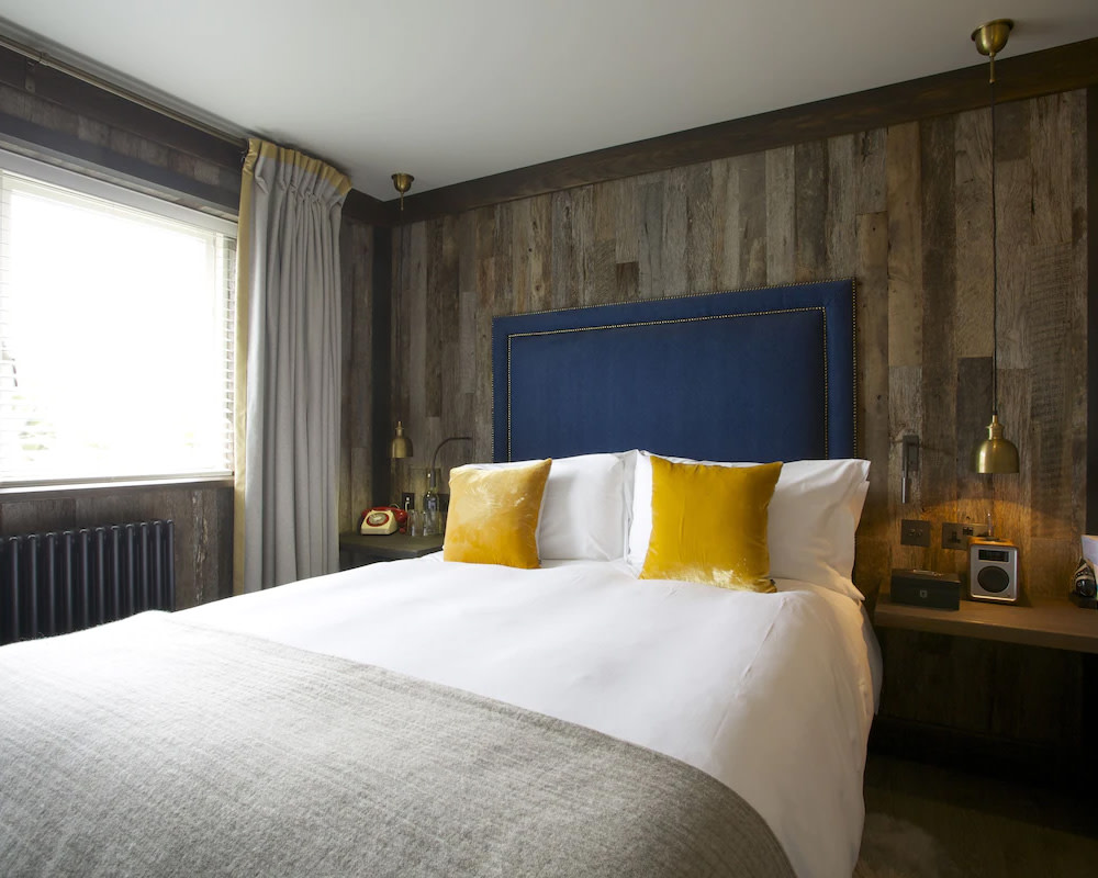 a hotel room with blue and yellow accents