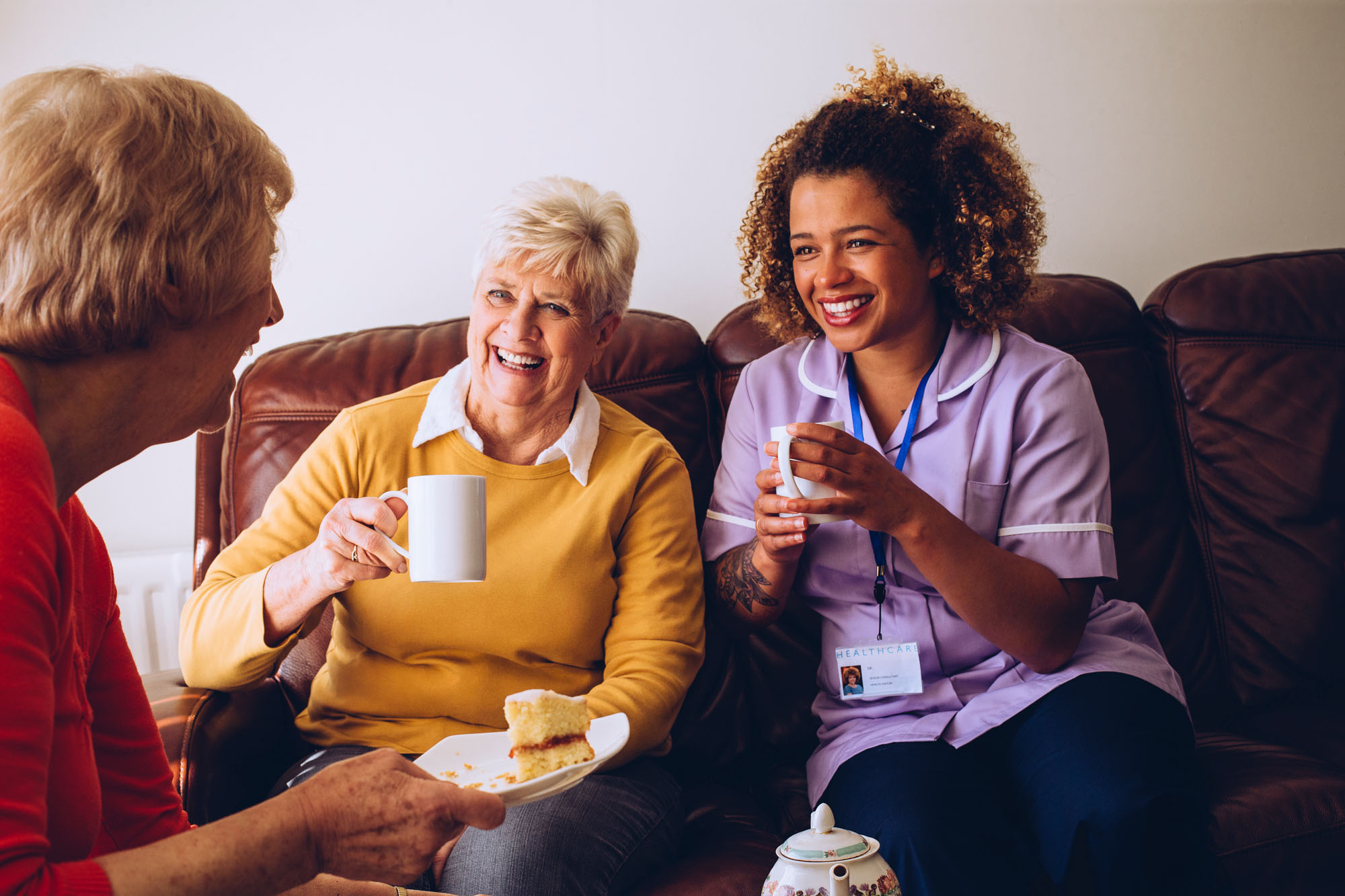 A nurse having coffee with 2 women