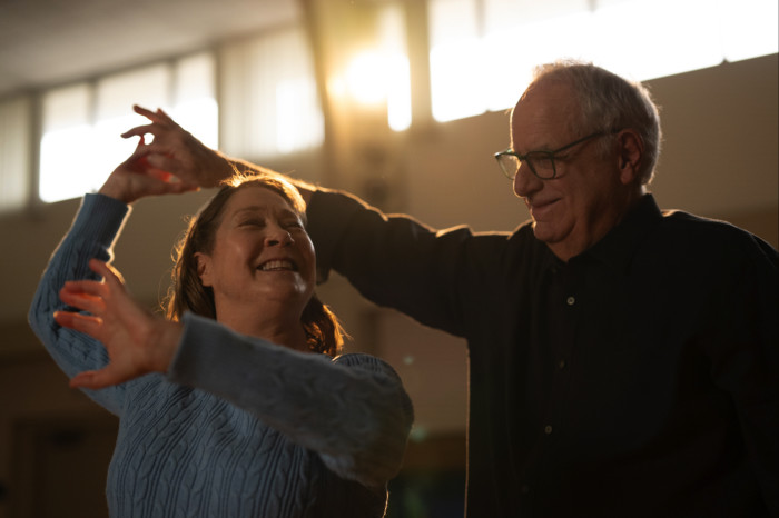 Two residents dancing in the sunlight