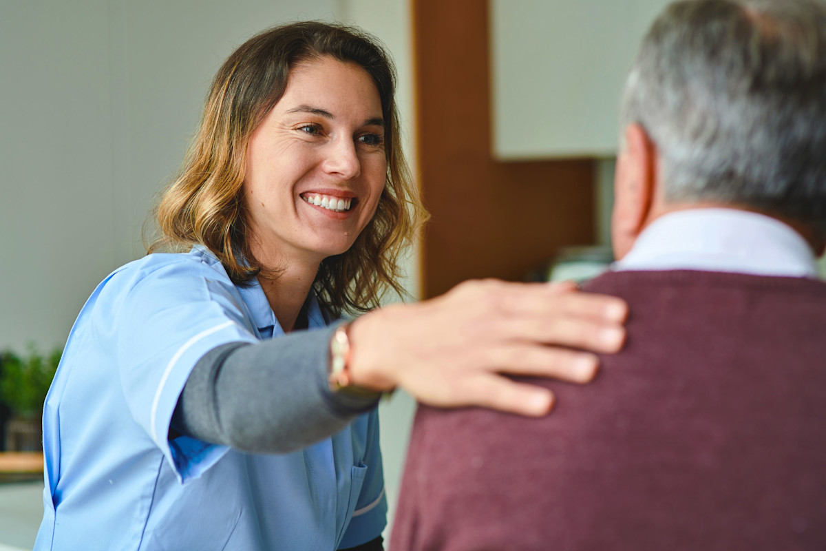 A nurse talking to a patient