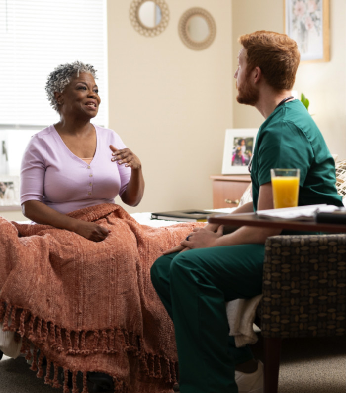 A resident speaking with a nurse