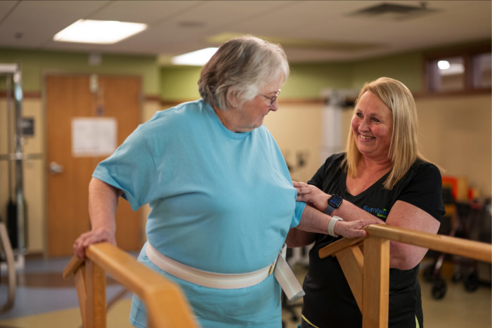 A woman working with a physical therapist
