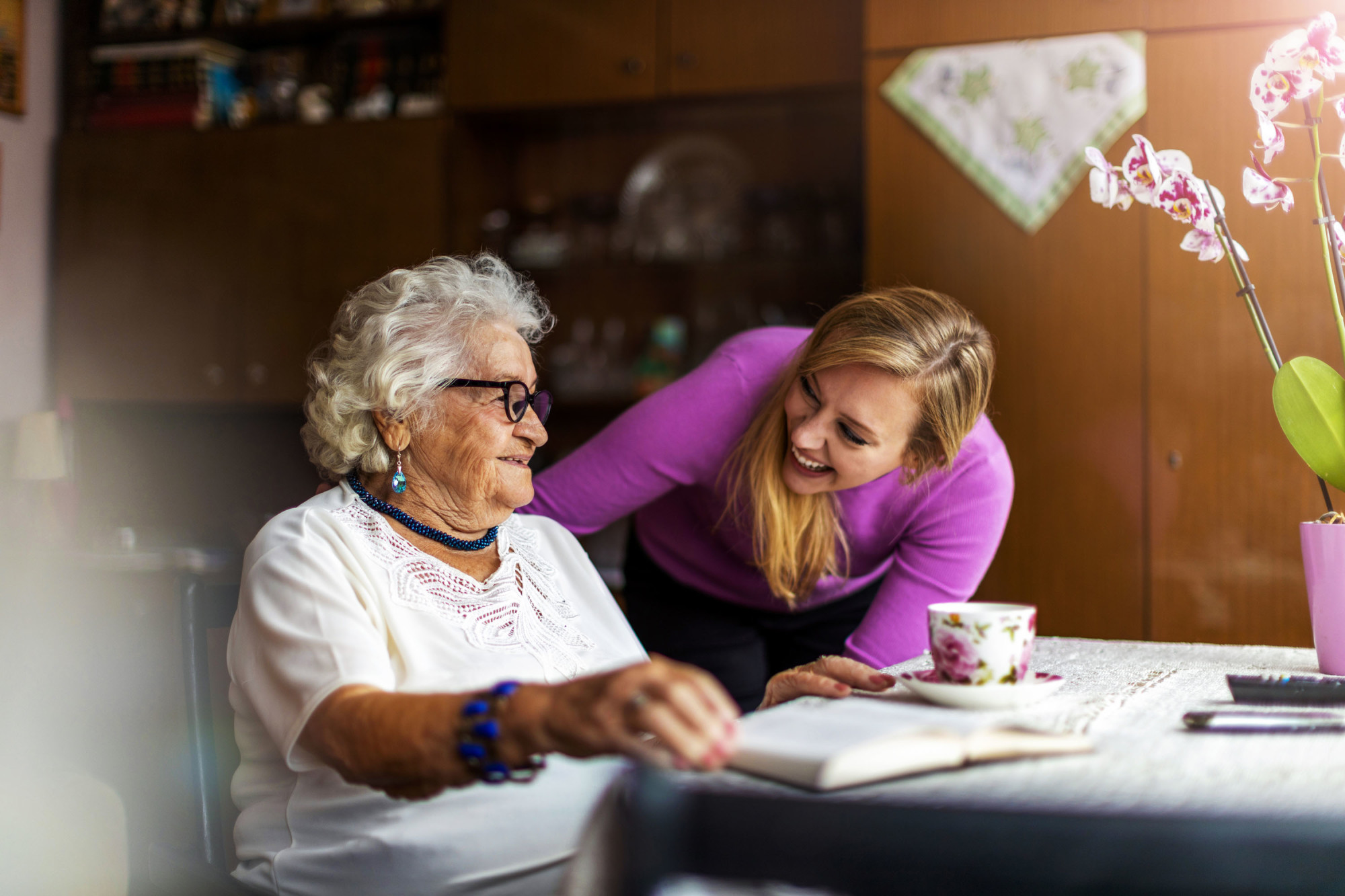 A woman greeting another at breakfast