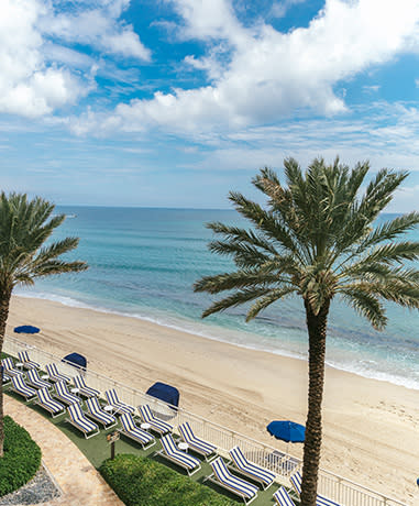 Aerial shot of cabanas on the beach.