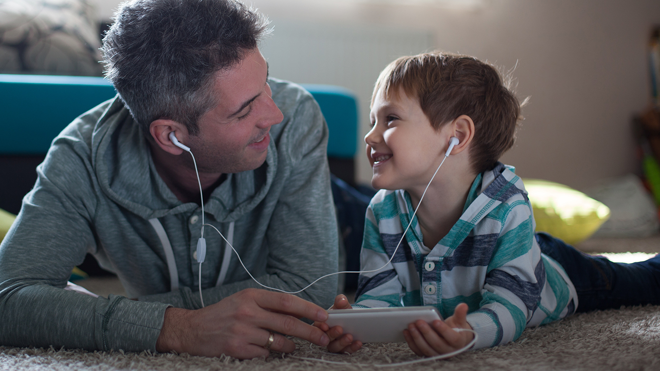 Father and son listening to bedtime stories together