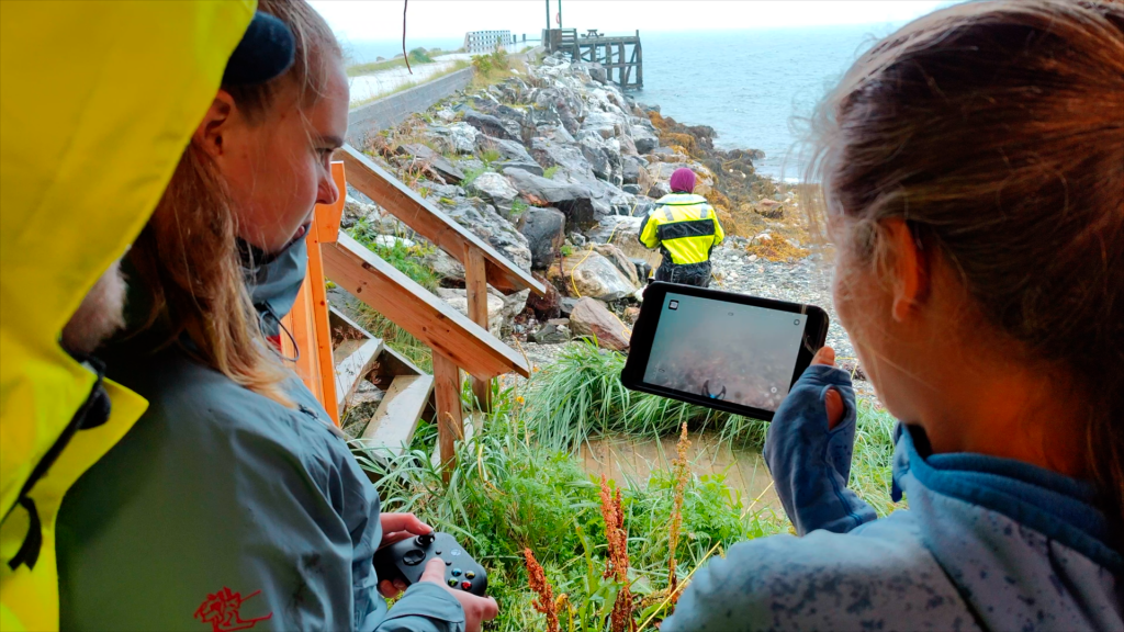 An UiT student looking at underwater footage from a Blueye drone on an Ipad