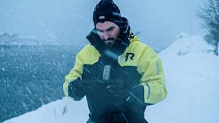 Person holding the Blueye Rugged controller in a snow storm