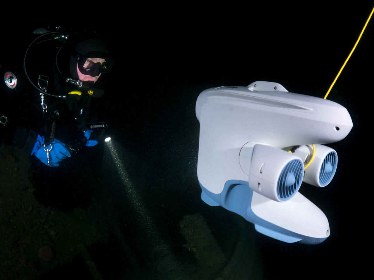 Software developer & scuba diver Jonas communicating with colleagues topside