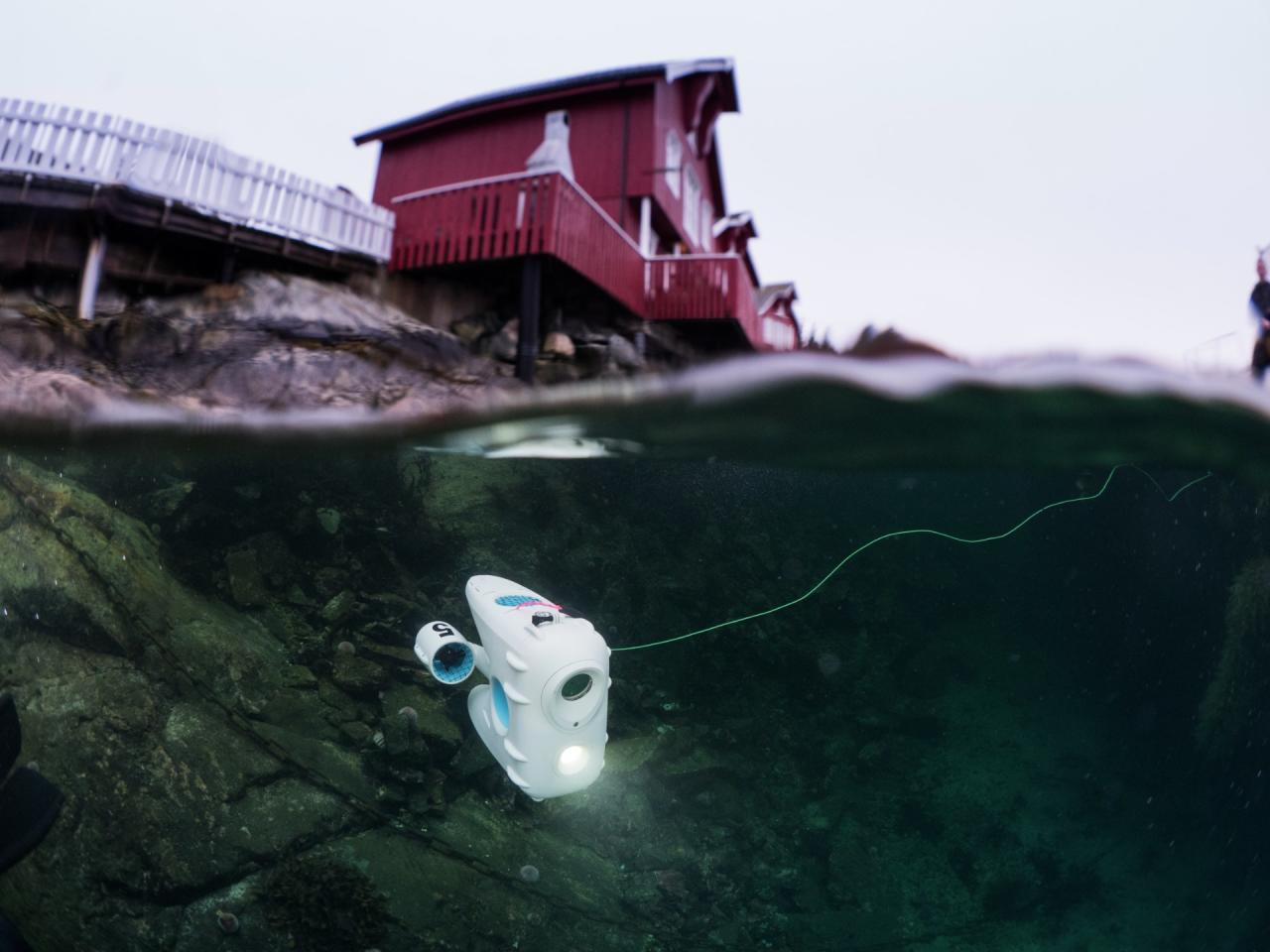 PioneerOne drone exploring the harbour of Kvenvær, in clear winter water