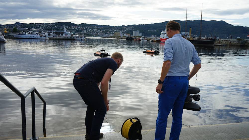 Blueye drone and Maritime Robotics Otter USV by the harbor