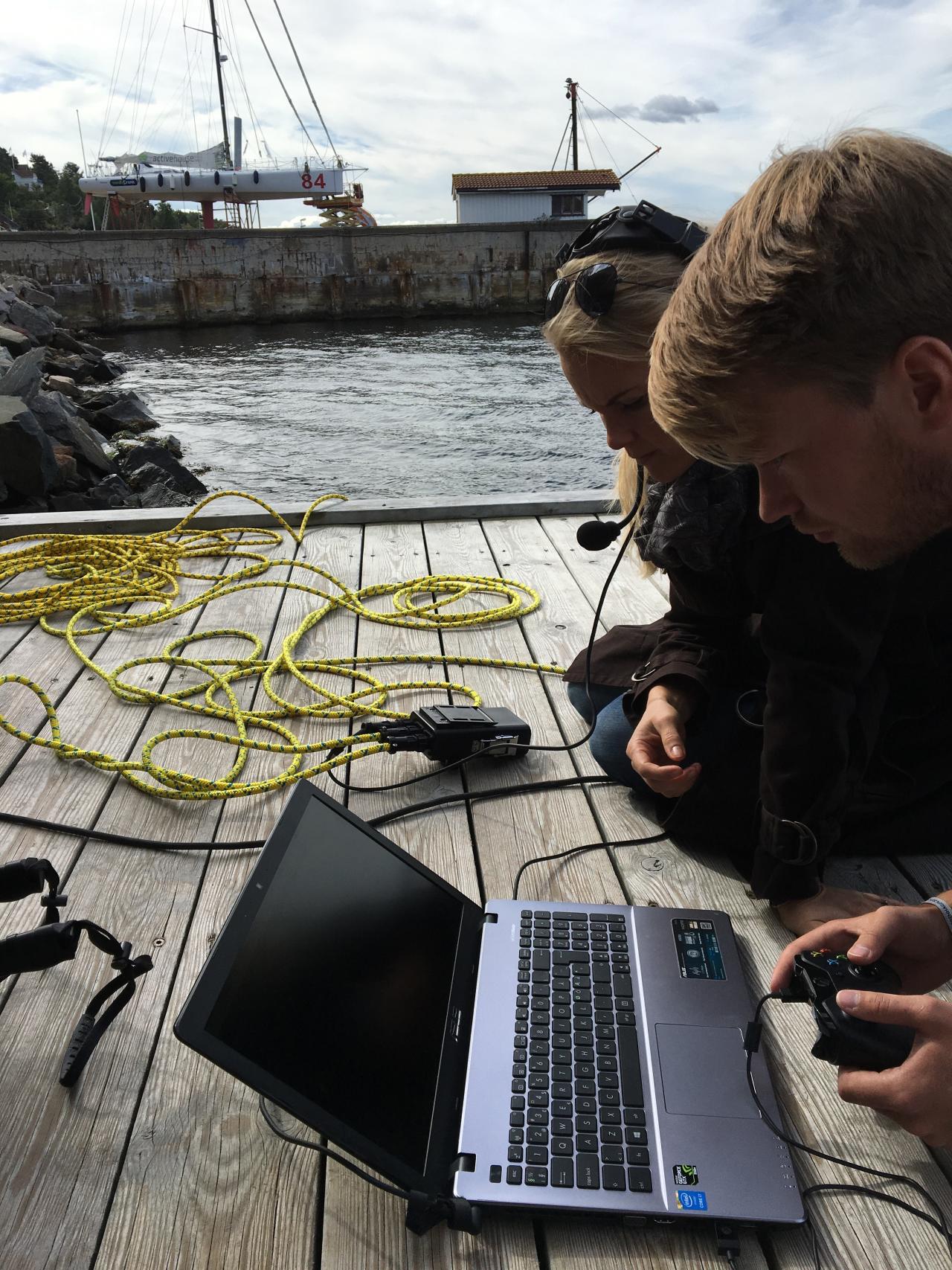 Andreas driving the drone with NRK's News Anchor,  watching closely to make a Live underwater interview.