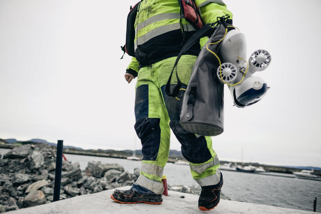 Man carrying blueye drone on assignment