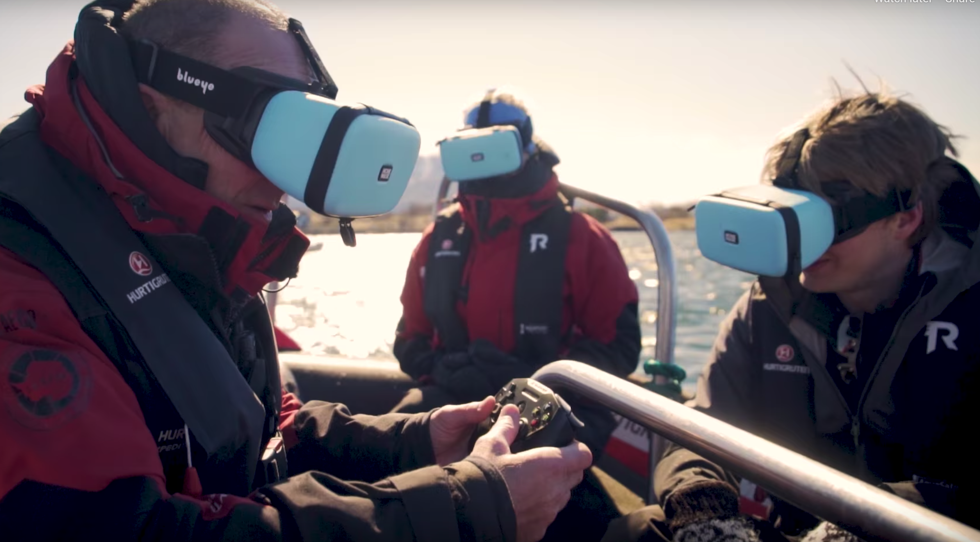 Guests in a boat enjoying live underwater video through a smartphone placed inside the MovieMask. 