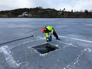 Making of the hole in the ice using chain saw