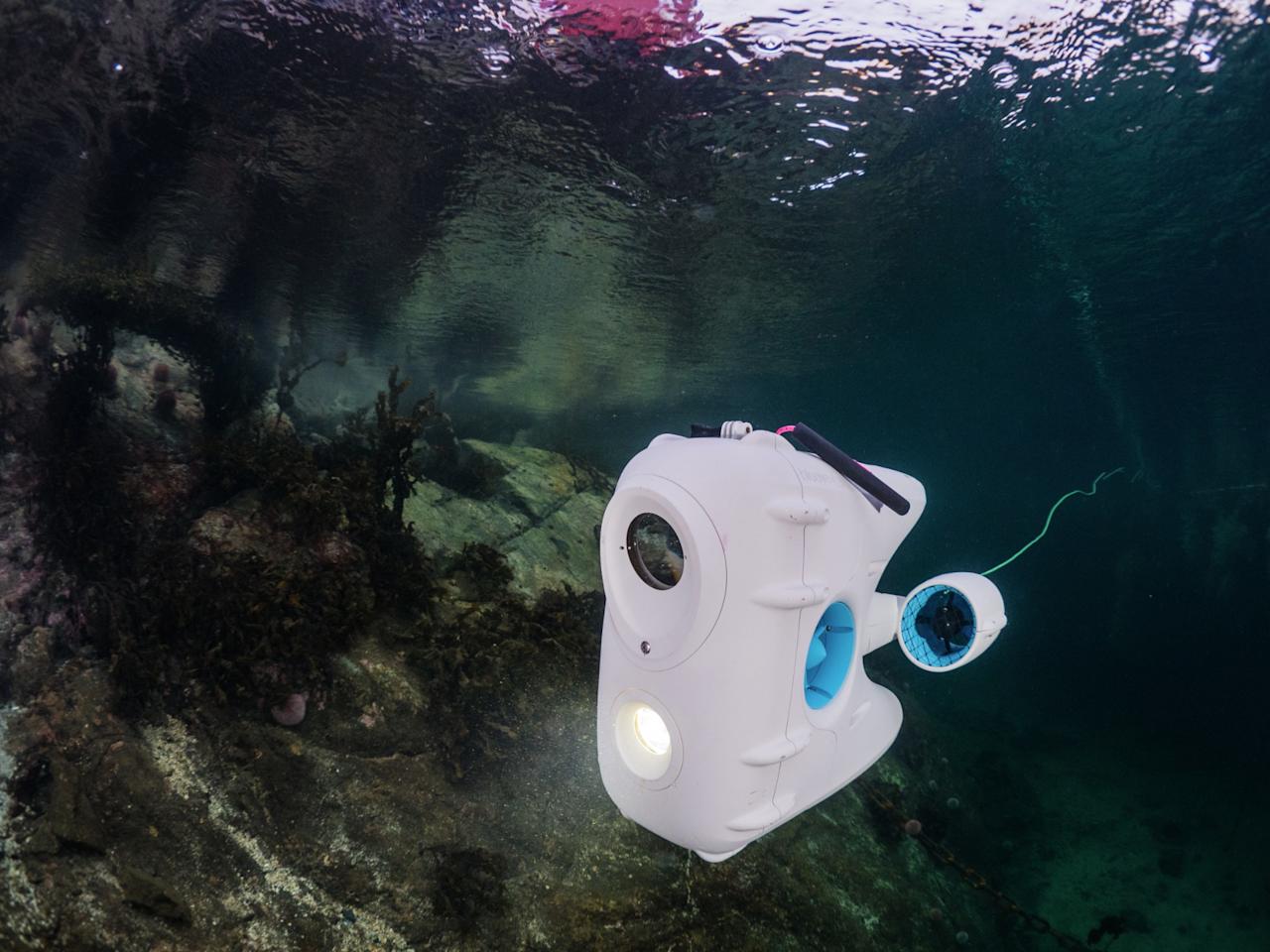PioneerOne drone exploring the harbour of Kvenvær, in clear winter water