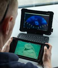 Operator using rugged controller and tablet watching Oculus sonar