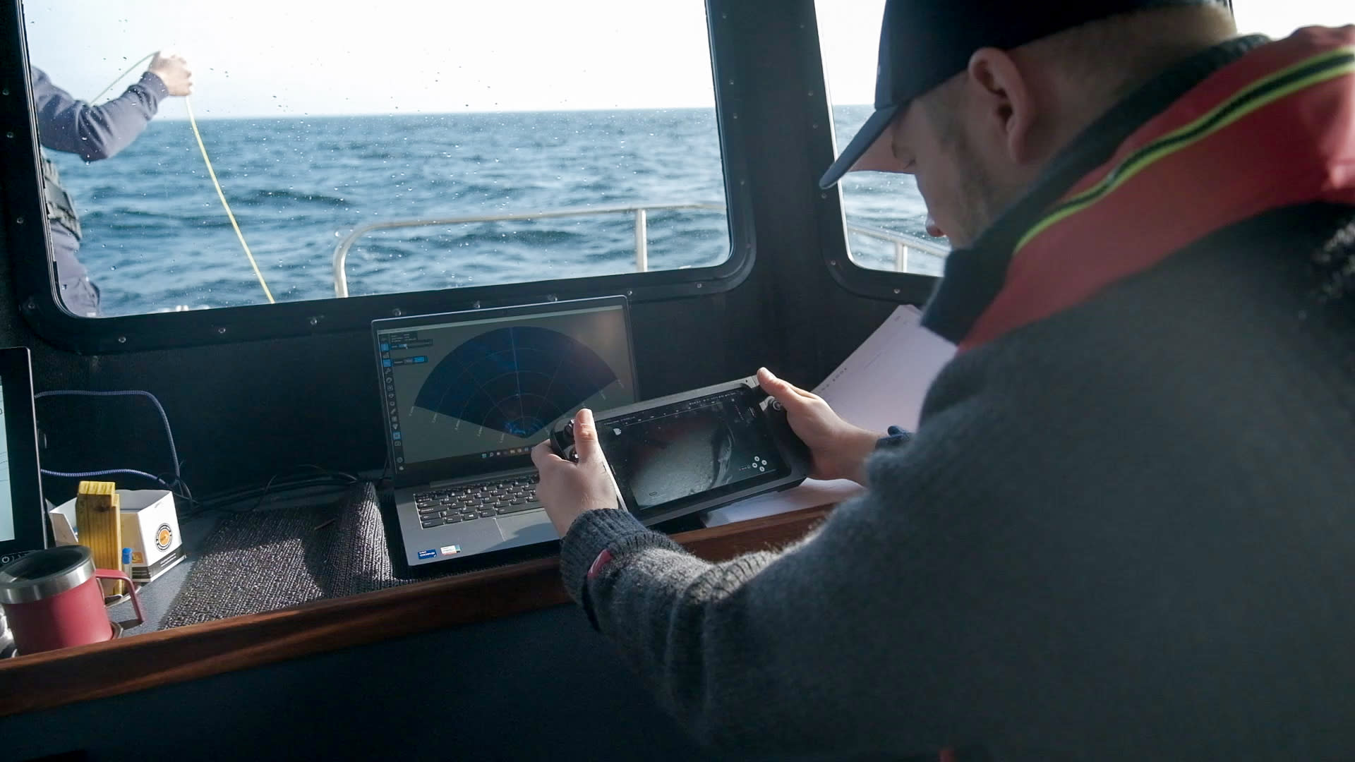 Trond Larsen and Expressen reporter looking at the smartphone and controller while at the Nord Stream blast site