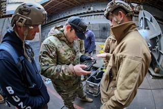 U.S. Navy Divers operating a Blueye ROV in the ballast tank of the ex-USS Fort McHenry