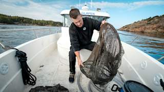 Arild Karlsen retrieves a catch bag on deck