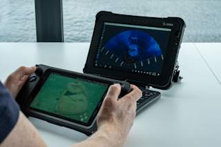 Operator using rugged controller and tablet watching Oculus sonar - horizontal