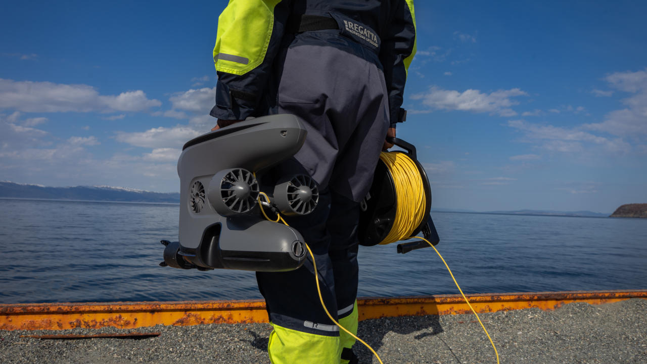 Holding the X3 ROV by the ocean