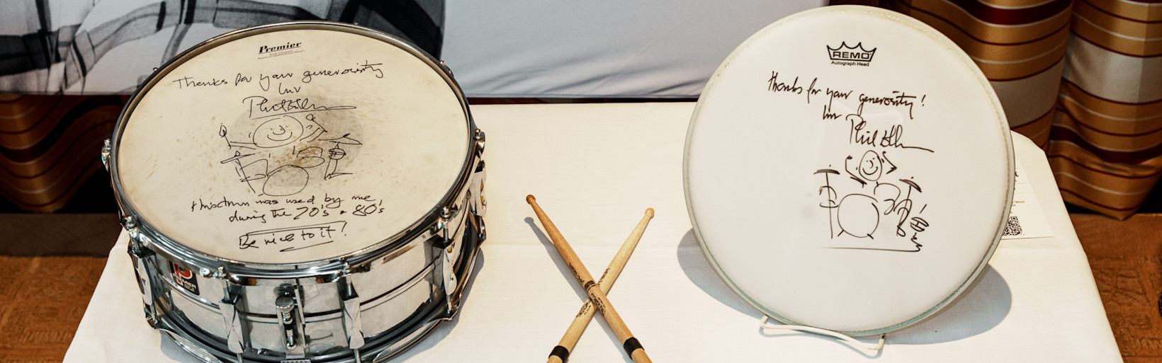 Signed in Collins's own hand with an illustrated self-portrait at the kit and an inscription: "This drum was used by me during the 70's + 80's / Be nice to it!"