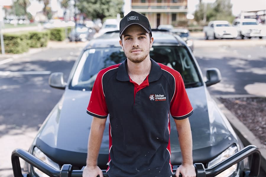 Young man sitting on hood of car 2