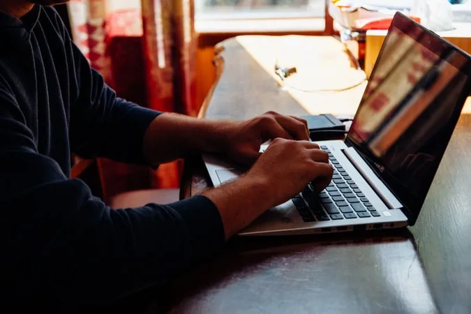 Boy in dark using laptop