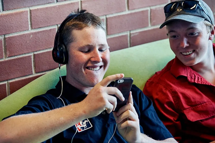 two guys smiling looking at phone1