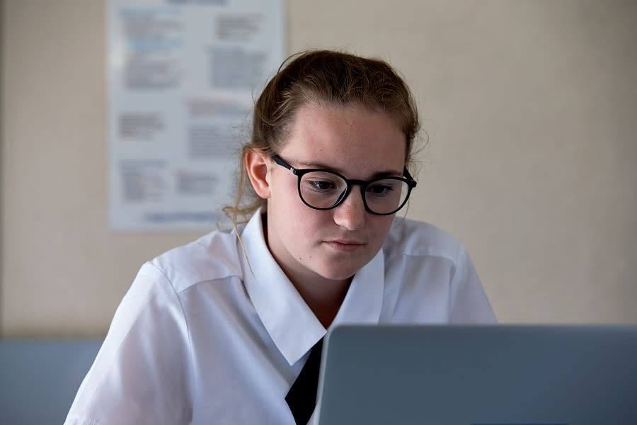 Student sits looking at computer