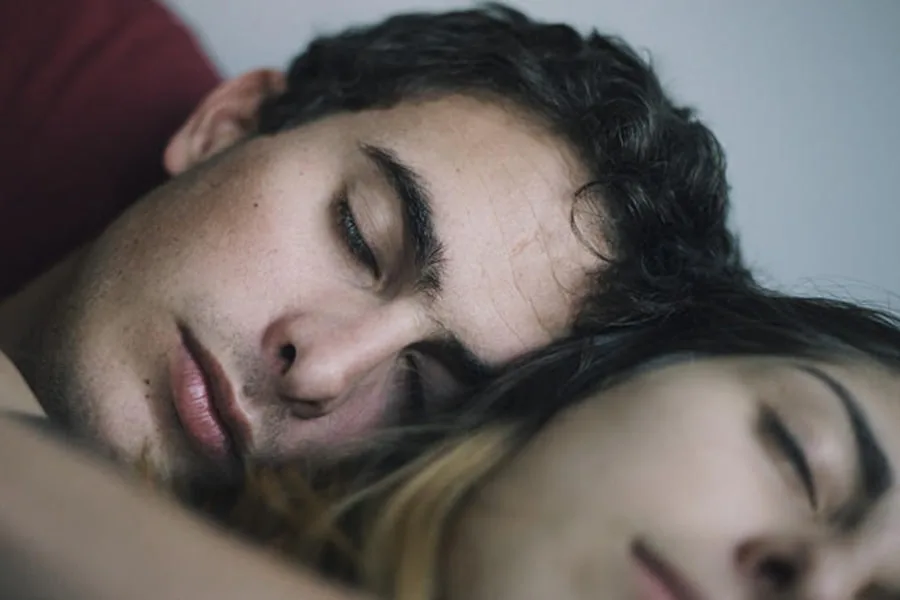 boy and girl sleeping together with eyes closed