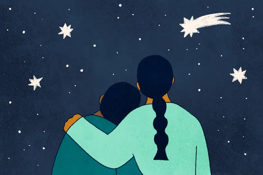 A mother has her arm wrapped around her child's shoulder as they look out at the starry night. 