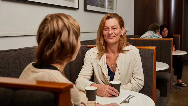 Mother and daughter talking at a cafe (1)