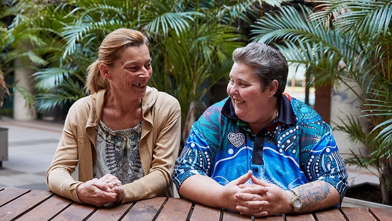 two aboriginal women talking and smiling