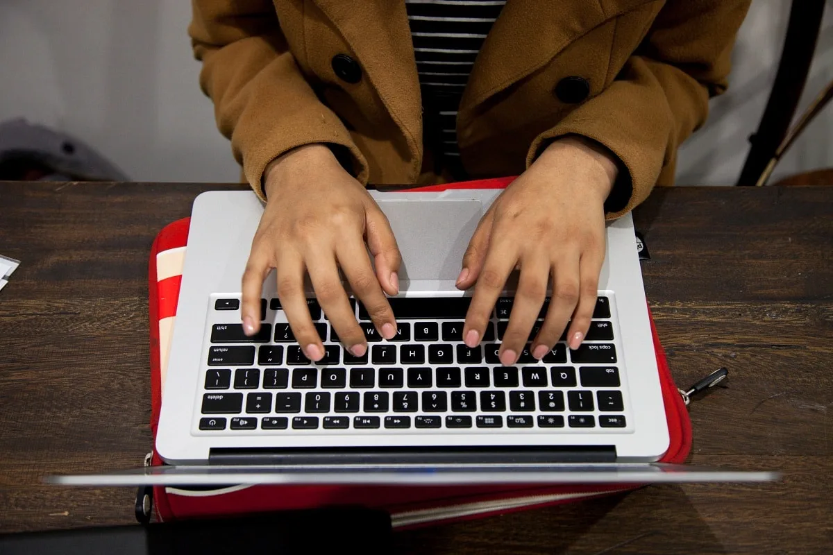 Boy typing on laptop computer