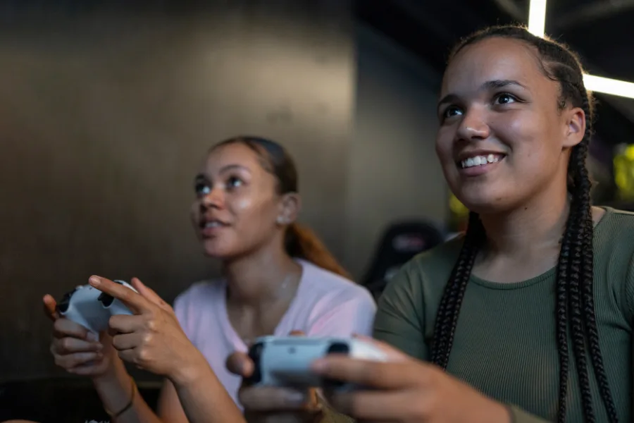 Two teenage girls playing a video game.