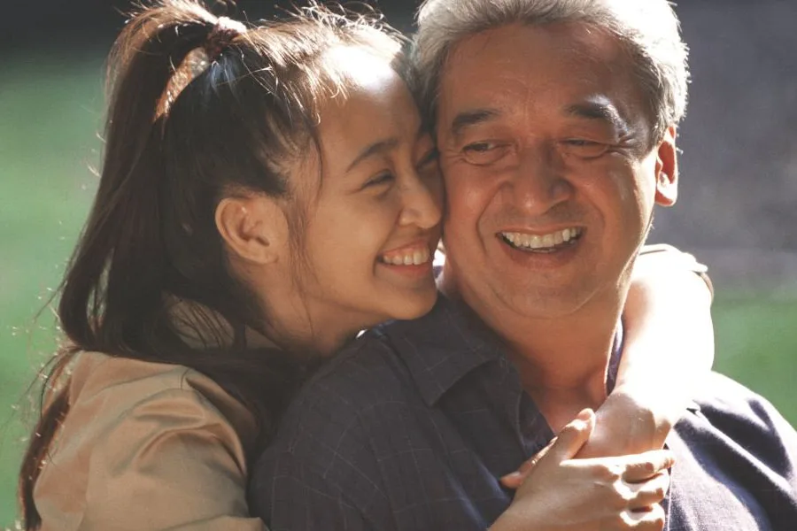 Daughter and father hugging and smiling