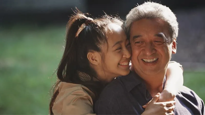 Daughter and father hugging and smiling