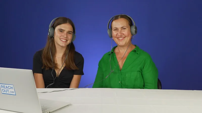 giulia and her mum elsa sitting down infront of a laptop