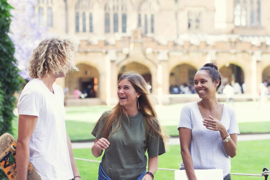 Three friends laughing at university. 