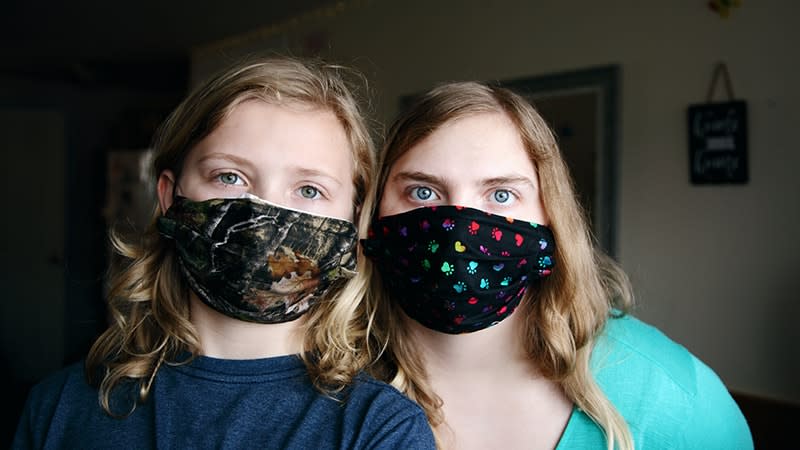 mum and teen wearing masks indoors