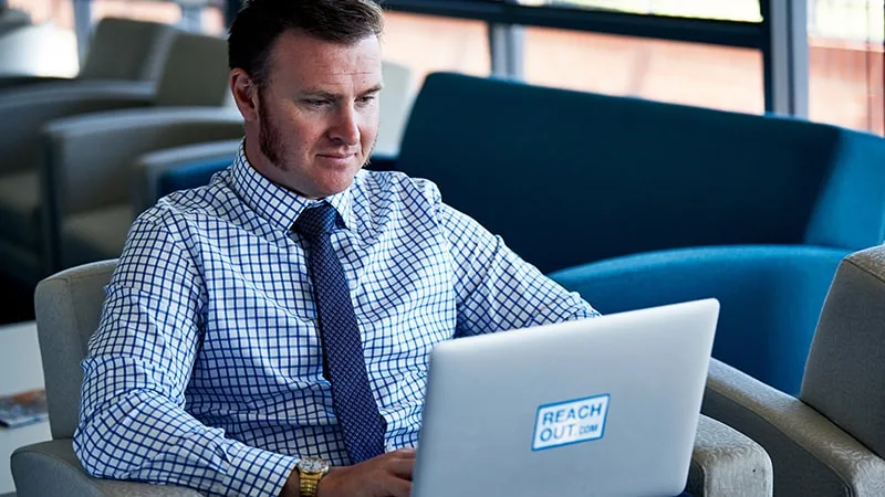 man looking at laptop